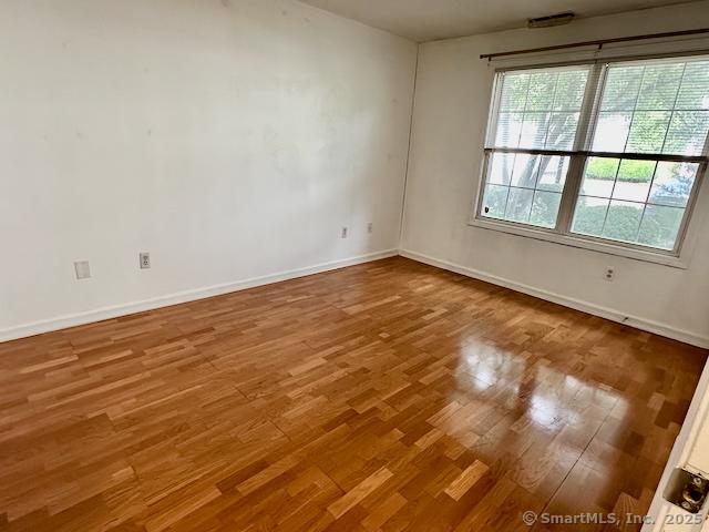 2390 State St Apt 7J, Hamden, CT 06517 - spare room with wood finished floors and baseboards
