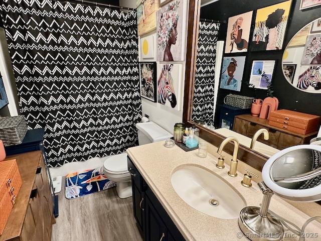 2390 State St Apt 7J, Hamden, CT 06517 - bathroom featuring vanity, curtained shower, and wood finished floors