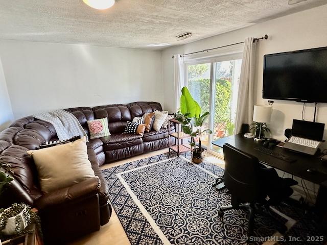 2390 State St Apt 7J, Hamden, CT 06517 - living area featuring a textured ceiling and a desk