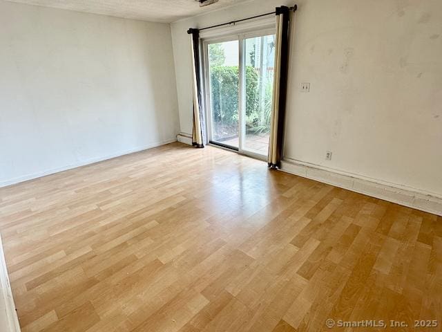2390 State St Apt 7J, Hamden, CT 06517 - spare room with light wood finished floors and baseboards