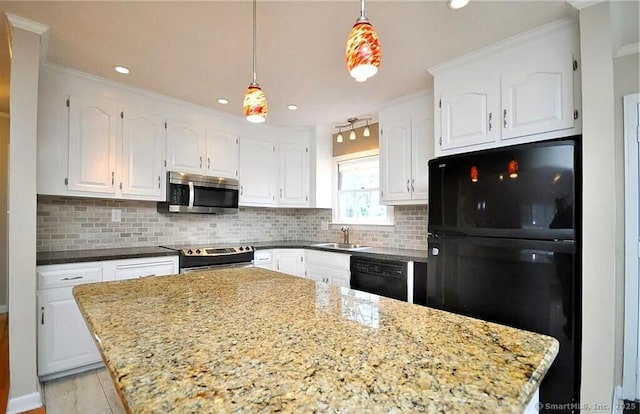 40 Mark St, Bristol, CT 06010 - kitchen with black appliances, white cabinets, backsplash, pendant lighting, and recessed lighting