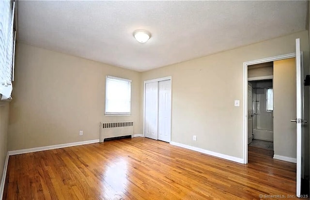 40 Mark St, Bristol, CT 06010 - unfurnished bedroom with radiator, light wood-style floors, and a closet