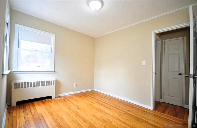 40 Mark St, Bristol, CT 06010 - empty room with radiator, wood finished floors, and ornamental molding