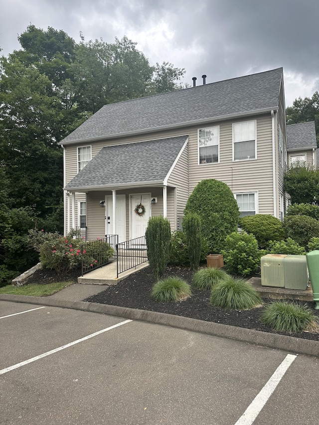 229 Branford Rd Unit 208, North Branford, CT 06471 - view of front facade featuring a shingled roof, uncovered parking, and covered porch