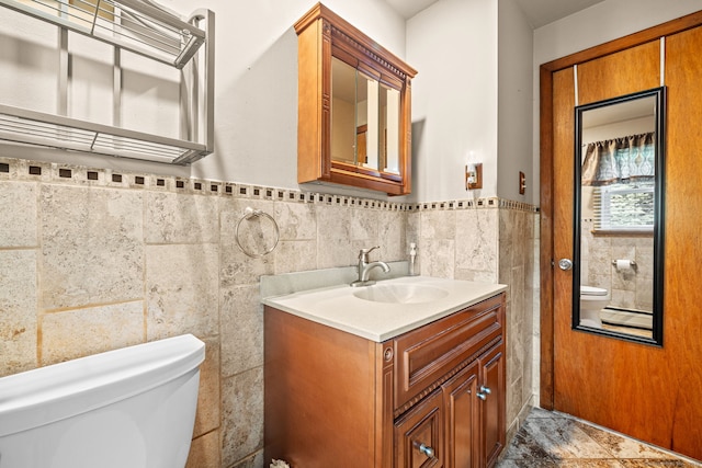 128 Auburn St, Stratford, CT 06614 - bathroom with vanity, tile walls, and a wainscoted wall