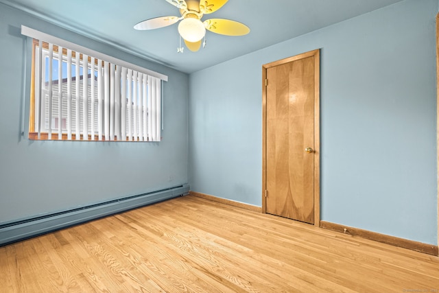 128 Auburn St, Stratford, CT 06614 - unfurnished room with baseboard heating, wood finished floors, and ceiling fan