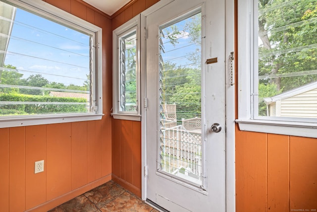 128 Auburn St, Stratford, CT 06614 - doorway to outside featuring healthy amount of natural light, wood walls, and stone finish flooring