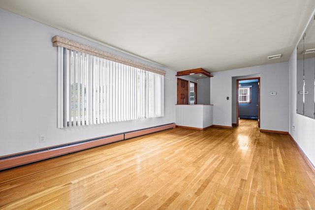128 Auburn St, Stratford, CT 06614 - unfurnished room with a baseboard heating unit, healthy amount of natural light, and wood finished floors