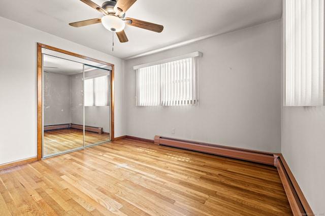 128 Auburn St, Stratford, CT 06614 - unfurnished bedroom with baseboard heating, wood finished floors, a baseboard heating unit, and a closet