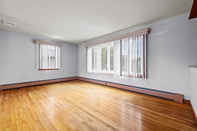 128 Auburn St, Stratford, CT 06614 - unfurnished room with wood finished floors, baseboard heating, and a baseboard heating unit