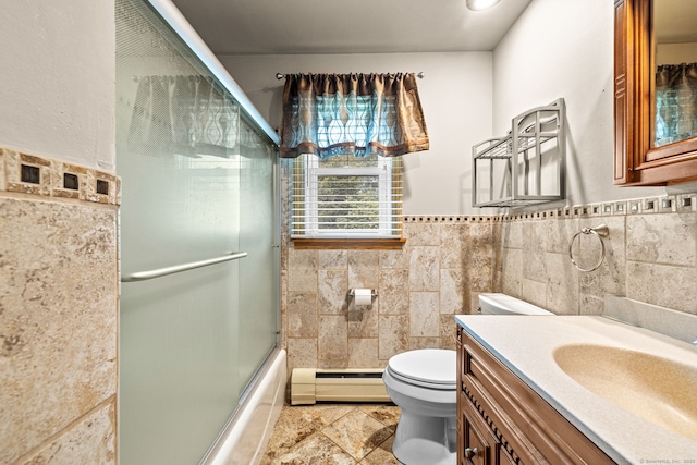 128 Auburn St, Stratford, CT 06614 - bathroom with a baseboard radiator, tile walls, vanity, combined bath / shower with glass door, and a wainscoted wall