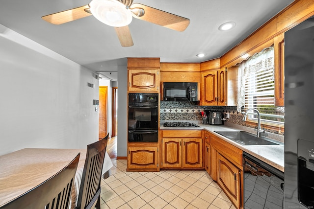 128 Auburn St, Stratford, CT 06614 - kitchen with black appliances, a warming drawer, decorative backsplash, light countertops, and brown cabinetry