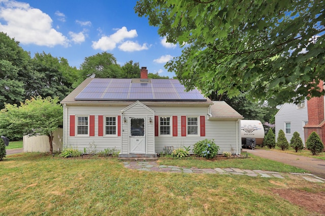 35 Oberlin Rd, Hamden, CT 06514 - view of front of house featuring a front lawn, a chimney, and roof mounted solar panels