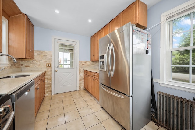 35 Oberlin Rd, Hamden, CT 06514 - kitchen featuring stainless steel appliances, radiator heating unit, healthy amount of natural light, tasteful backsplash, and recessed lighting
