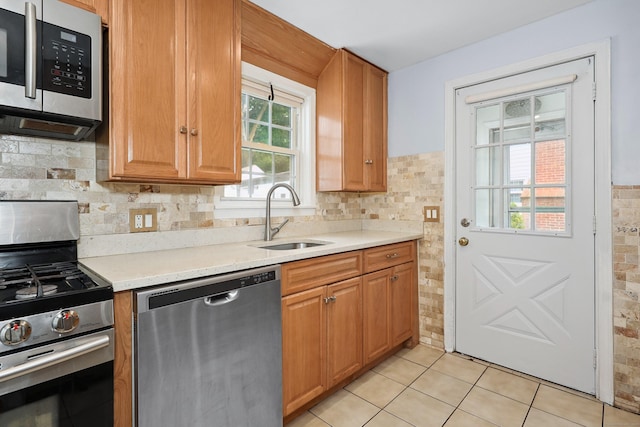 35 Oberlin Rd, Hamden, CT 06514 - kitchen featuring appliances with stainless steel finishes, light countertops, backsplash, and light tile patterned floors