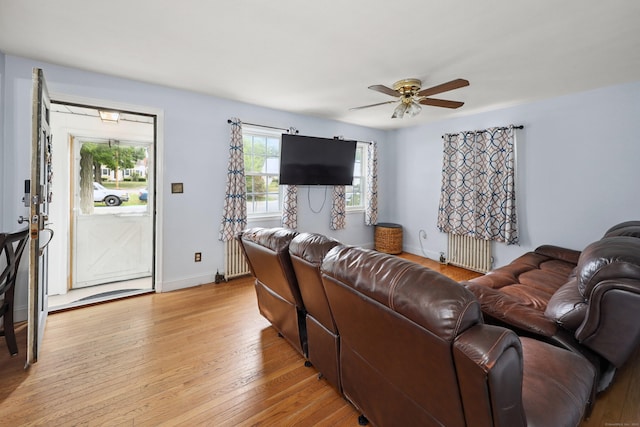 35 Oberlin Rd, Hamden, CT 06514 - living area featuring radiator heating unit, ceiling fan, and light wood-style flooring