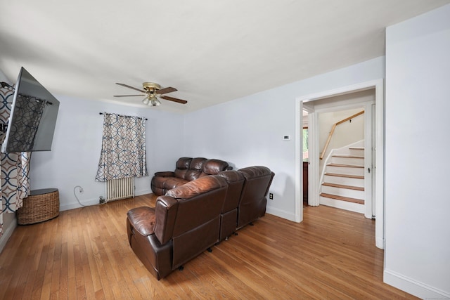 35 Oberlin Rd, Hamden, CT 06514 - living room with radiator, light wood-type flooring, ceiling fan, and stairway