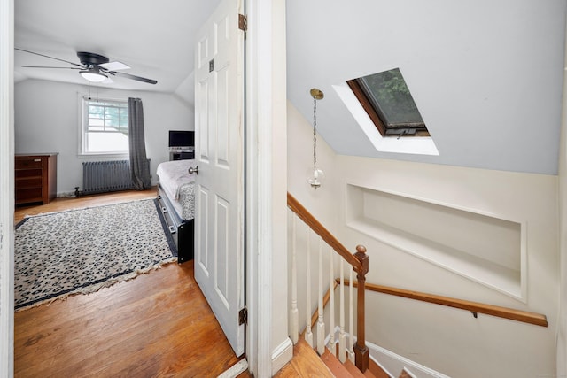 35 Oberlin Rd, Hamden, CT 06514 - staircase featuring radiator, a skylight, wood finished floors, vaulted ceiling, and ceiling fan