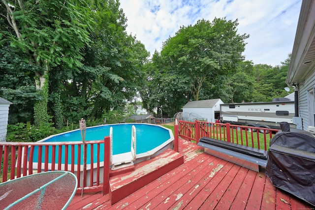 35 Oberlin Rd, Hamden, CT 06514 - outdoor pool featuring a storage shed, a wooden deck, and area for grilling