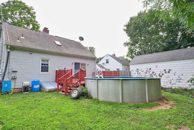 35 Oberlin Rd, Hamden, CT 06514 - rear view of property featuring a lawn, a chimney, and an outdoor pool