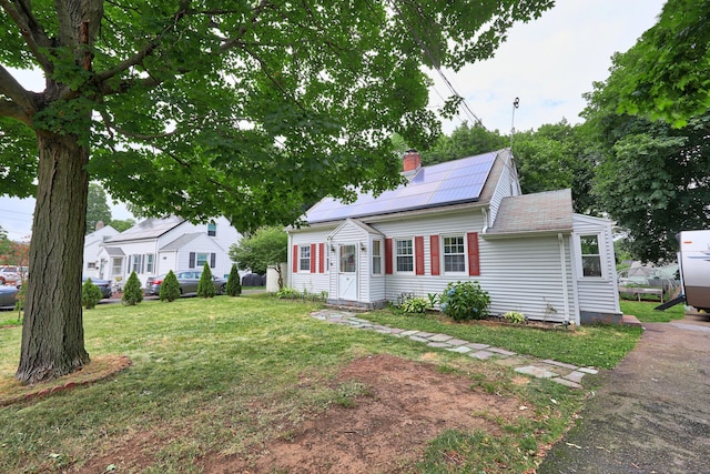 35 Oberlin Rd, Hamden, CT 06514 - view of front of property featuring roof mounted solar panels, a chimney, and a front lawn
