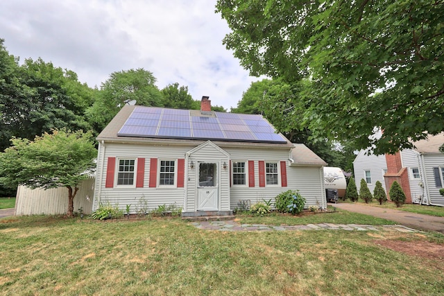 35 Oberlin Rd, Hamden, CT 06514 - view of front of house featuring a chimney, a front yard, and roof mounted solar panels