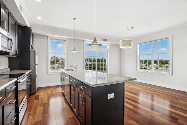 142 E Ave Unit A302, Norwalk, CT 06851 - kitchen featuring stainless steel appliances, ornamental molding, dark wood-style floors, an island with sink, and light stone counters