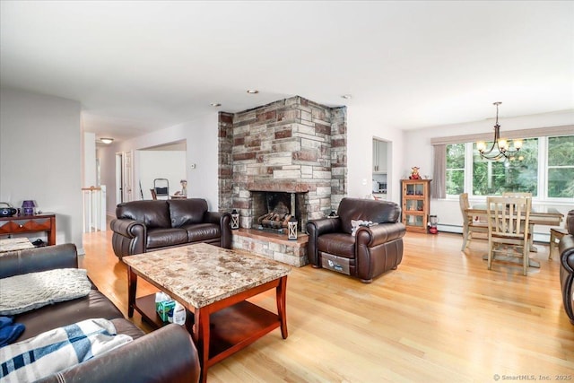 129 Russell Ave, Orange, CT 06477 - living room featuring light wood-style floors, a chandelier, a fireplace, and baseboard heating