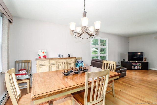 129 Russell Ave, Orange, CT 06477 - dining area with a chandelier, light wood finished floors, and a baseboard heating unit