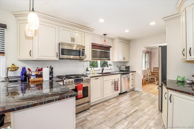 129 Russell Ave, Orange, CT 06477 - kitchen with stainless steel appliances, light wood-type flooring, a peninsula, recessed lighting, and dark stone countertops