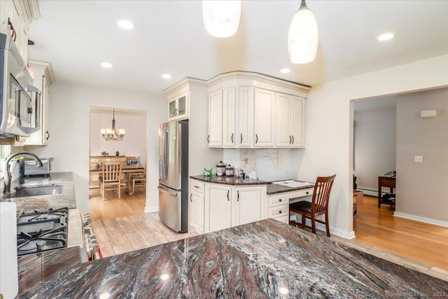129 Russell Ave, Orange, CT 06477 - kitchen featuring stainless steel appliances, light wood-style flooring, a baseboard heating unit, dark stone counters, and recessed lighting