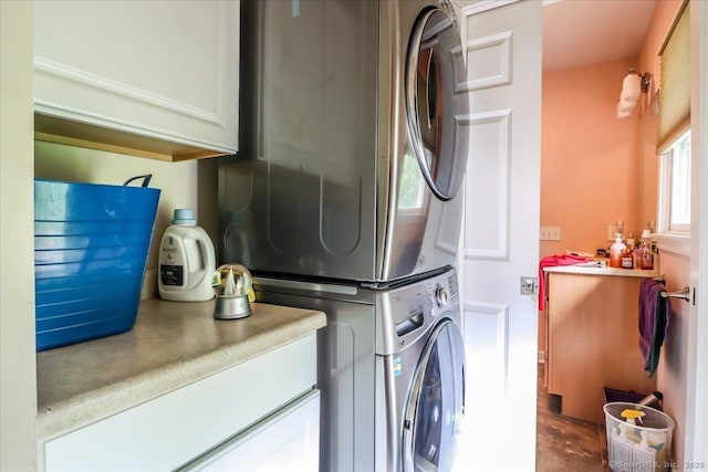 129 Russell Ave, Orange, CT 06477 - laundry area featuring stacked washer and clothes dryer and cabinet space