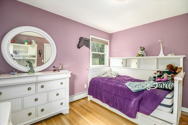 129 Russell Ave, Orange, CT 06477 - bedroom with a baseboard heating unit and light wood-style flooring