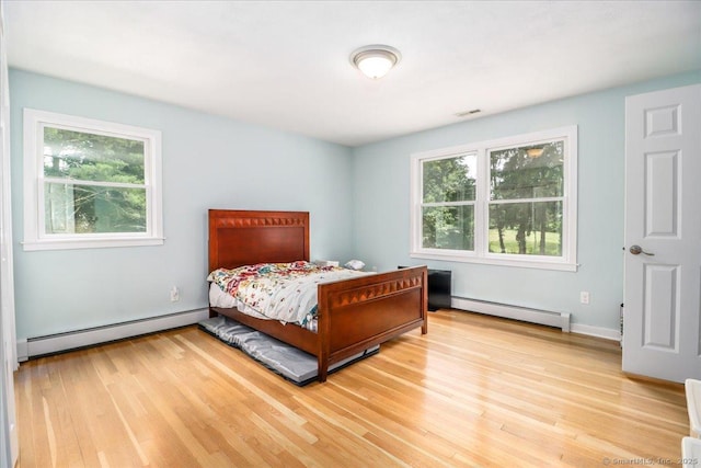 129 Russell Ave, Orange, CT 06477 - bedroom featuring a baseboard heating unit and light wood-style flooring