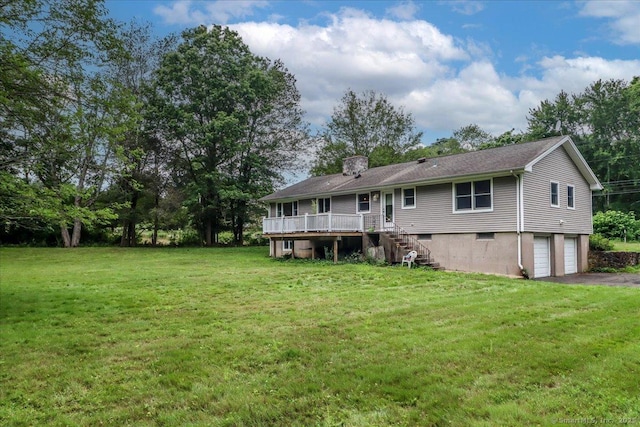 129 Russell Ave, Orange, CT 06477 - back of house featuring stairway, a garage, a yard, asphalt driveway, and a wooden deck