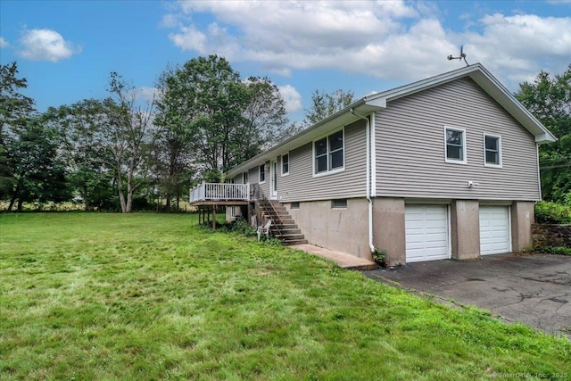 129 Russell Ave, Orange, CT 06477 - view of side of home featuring stairway, a garage, a yard, a deck, and asphalt driveway