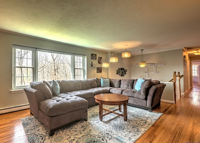 662 Booth Hill Rd, Trumbull, CT 06611 - living room with baseboard heating, hardwood / wood-style floors, plenty of natural light, crown molding, and a ceiling fan