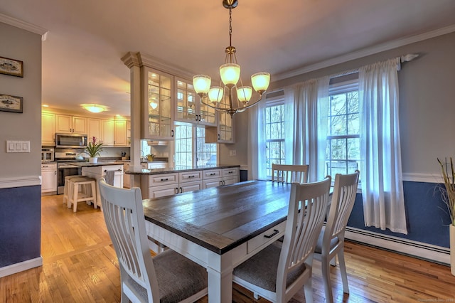 662 Booth Hill Rd, Trumbull, CT 06611 - dining space with baseboard heating, a chandelier, ornamental molding, and light wood-style floors