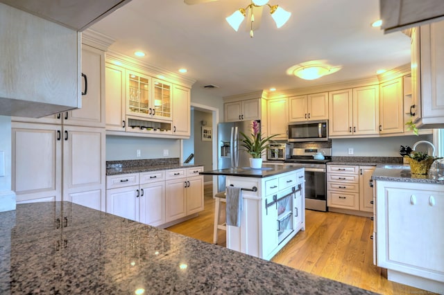 662 Booth Hill Rd, Trumbull, CT 06611 - kitchen with appliances with stainless steel finishes, light wood-type flooring, ceiling fan, dark stone countertops, and recessed lighting