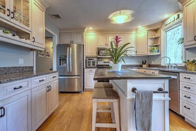662 Booth Hill Rd, Trumbull, CT 06611 - kitchen featuring stainless steel appliances, a kitchen island, open shelves, light wood finished floors, and recessed lighting