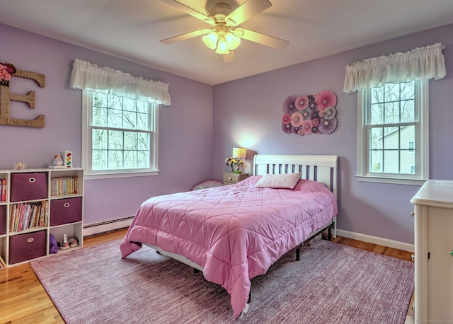 662 Booth Hill Rd, Trumbull, CT 06611 - bedroom with a baseboard heating unit, wood finished floors, and a ceiling fan
