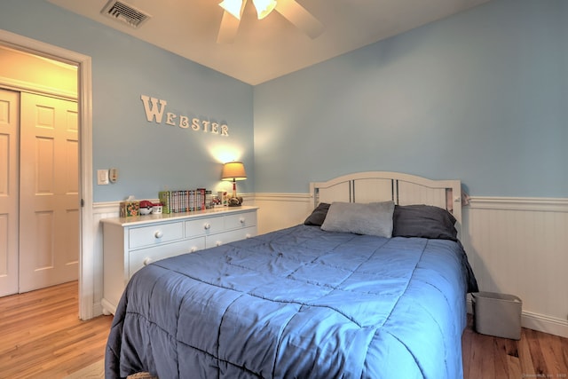 662 Booth Hill Rd, Trumbull, CT 06611 - bedroom featuring a wainscoted wall, light wood-style flooring, and a ceiling fan