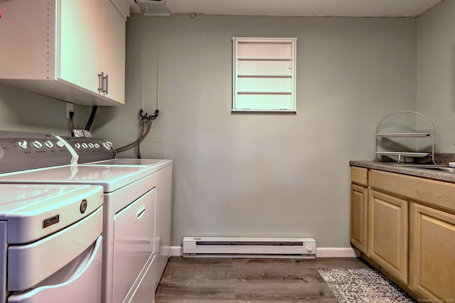 662 Booth Hill Rd, Trumbull, CT 06611 - laundry room with baseboard heating, washing machine and clothes dryer, cabinet space, and wood finished floors