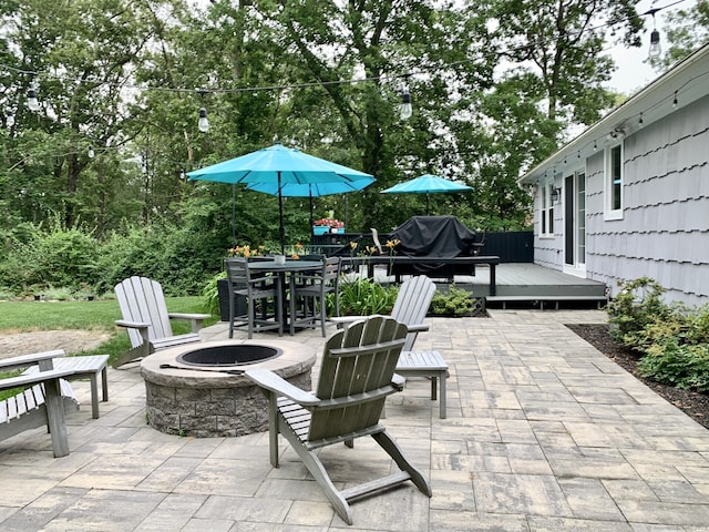 662 Booth Hill Rd, Trumbull, CT 06611 - view of patio / terrace featuring a fire pit, outdoor dining space, a wooden deck, and grilling area