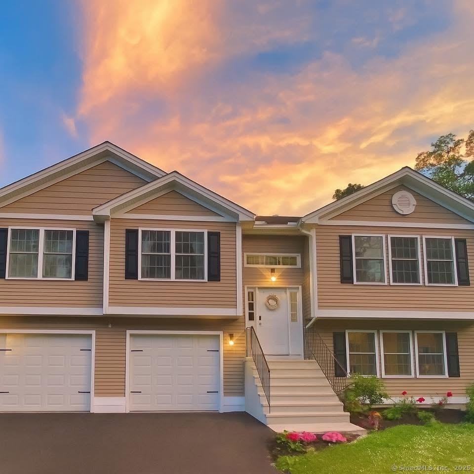 264 Central Ave, Wolcott, CT 06716 - bi-level home featuring driveway and an attached garage