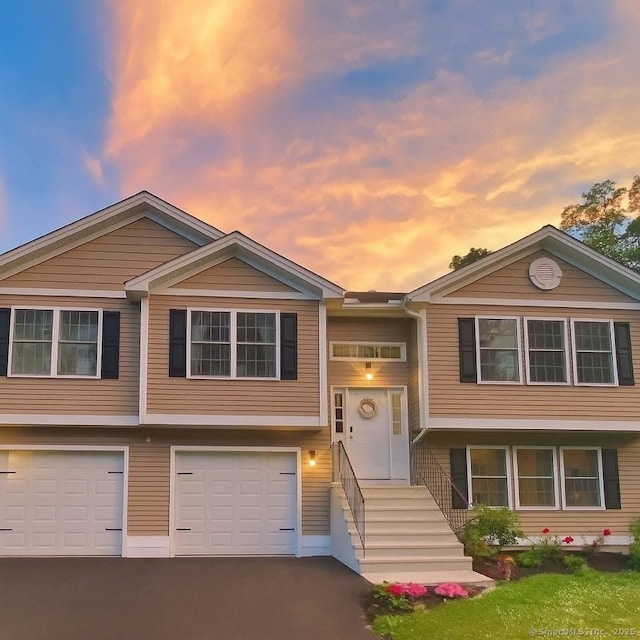 264 Central Ave, Wolcott, CT 06716 - bi-level home featuring driveway and an attached garage