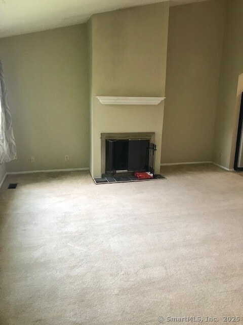 75 Lawson Ln Unit 75, Ridgefield, CT 06877 - unfurnished living room with a glass covered fireplace and carpet floors