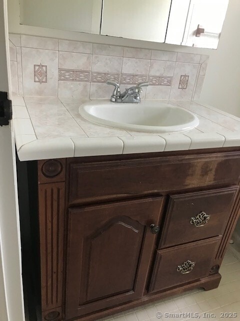 75 Lawson Ln Unit 75, Ridgefield, CT 06877 - bathroom with vanity, tasteful backsplash, and tile patterned floors