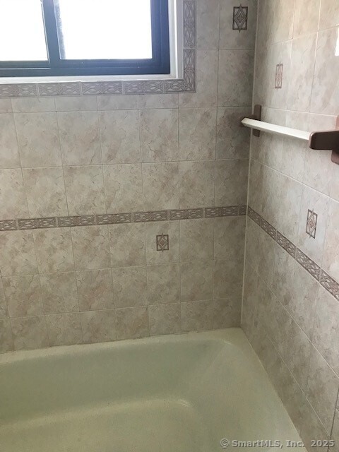 75 Lawson Ln Unit 75, Ridgefield, CT 06877 - bathroom featuring a bath and a shower