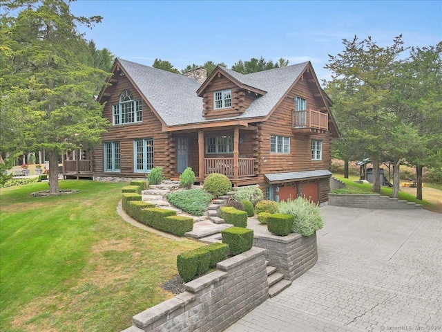 187 Chaplin Rd, Eastford, CT 06242 - log-style house featuring log exterior, driveway, an attached garage, a front lawn, and a balcony